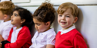 primary school children sitting togerher
